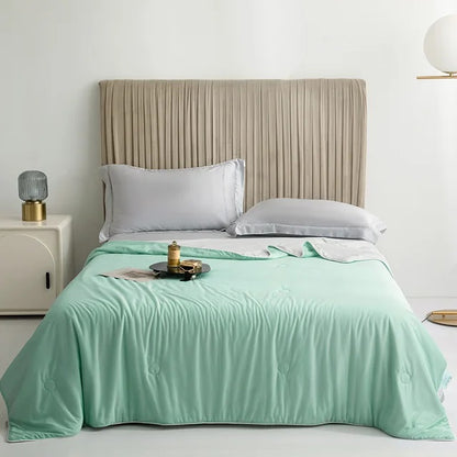 Cooling Blankets Smooth Air Condition Comforter in various colors, designed for summertime comfort, displayed on a bed in a modern bedroom setting.