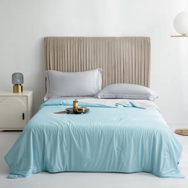 Cooling Blankets Smooth Air Condition Comforter in various colors, designed for summertime comfort, displayed on a bed in a modern bedroom setting.