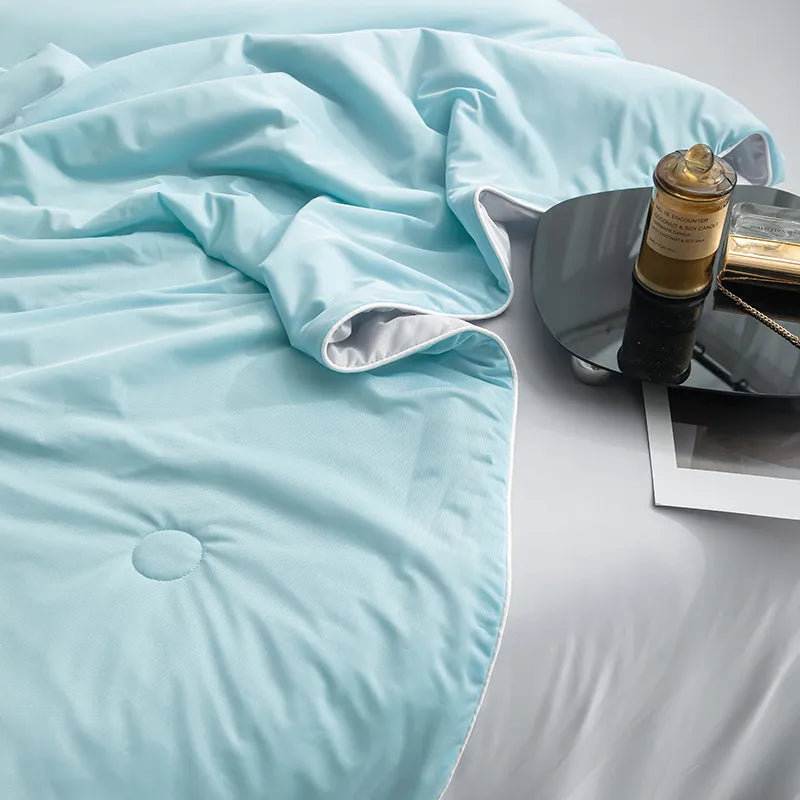 Cooling Blankets Smooth Air Condition Comforter in various colors, designed for summertime comfort, displayed on a bed in a modern bedroom setting.