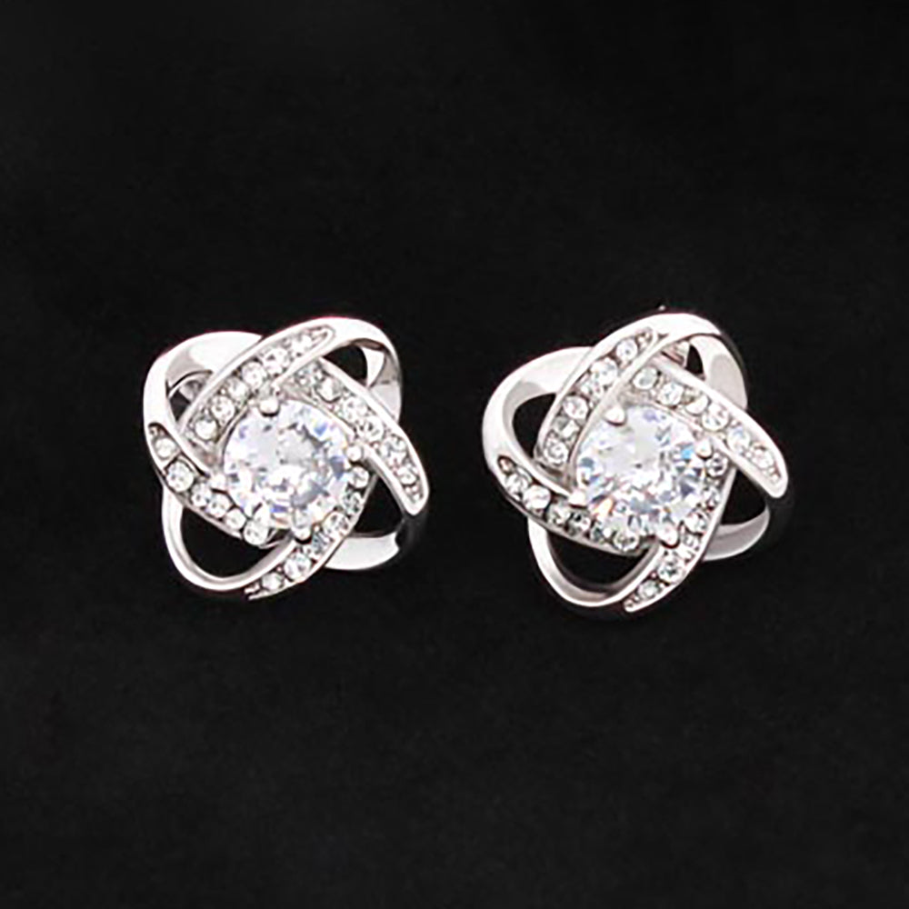 intricate love knot design with cubic zirconia